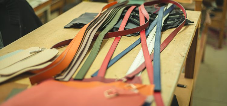 Inside of a boot workshop, with leather for making custom clutches and handbags.