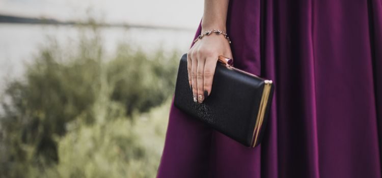 Person holding a custom leather clutch.